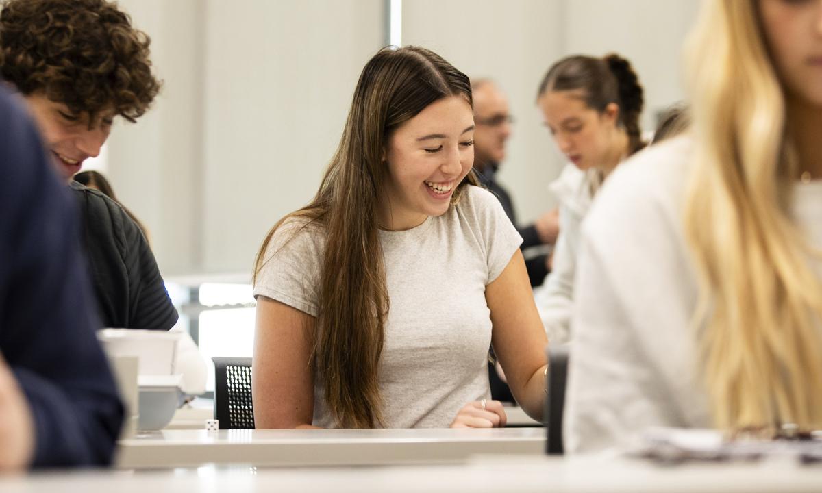 Photo of a girl smiling at a desk